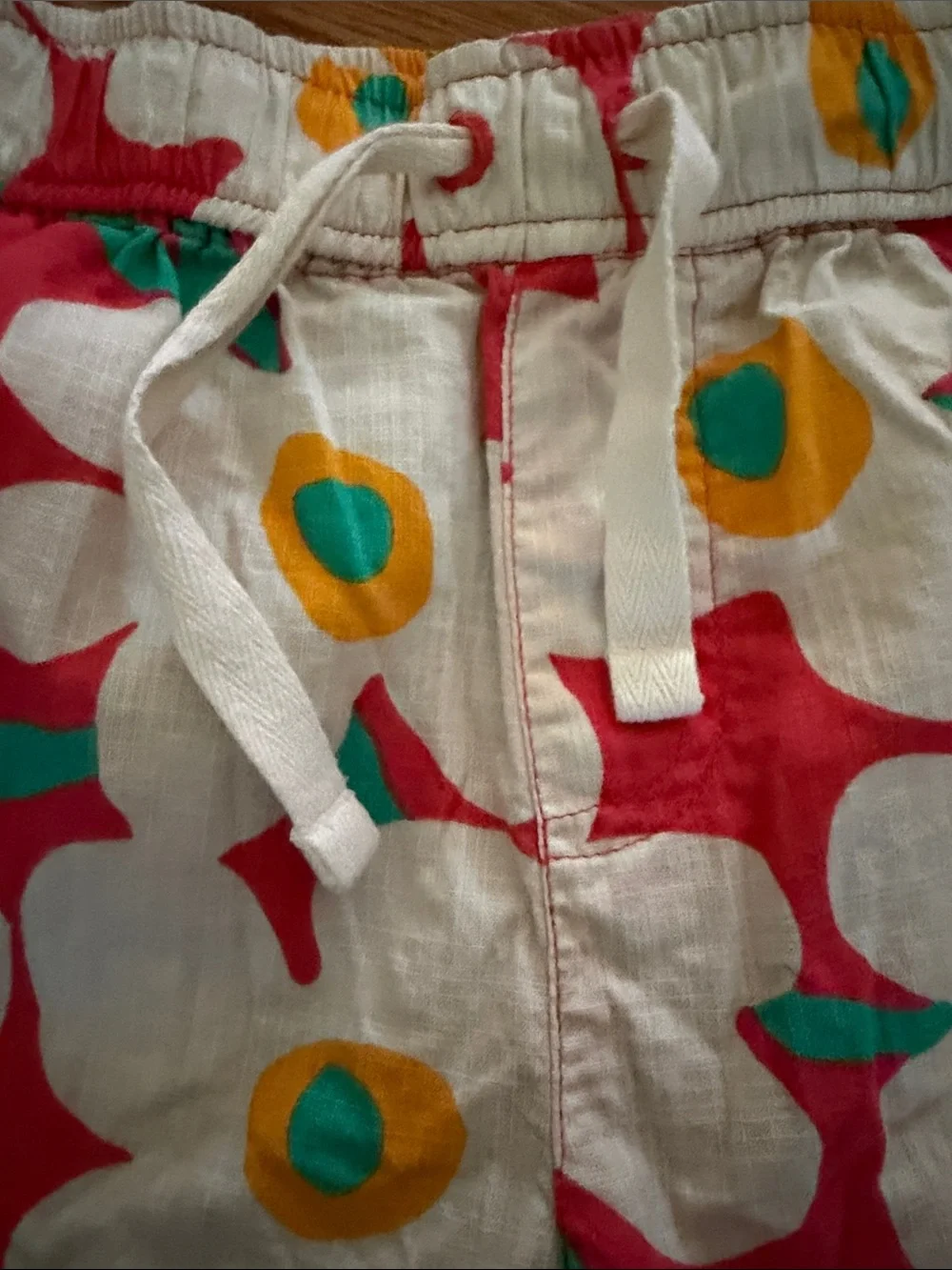 Hanna Andersson White Floral swim shorts with Red, Yellow & Teal Accents